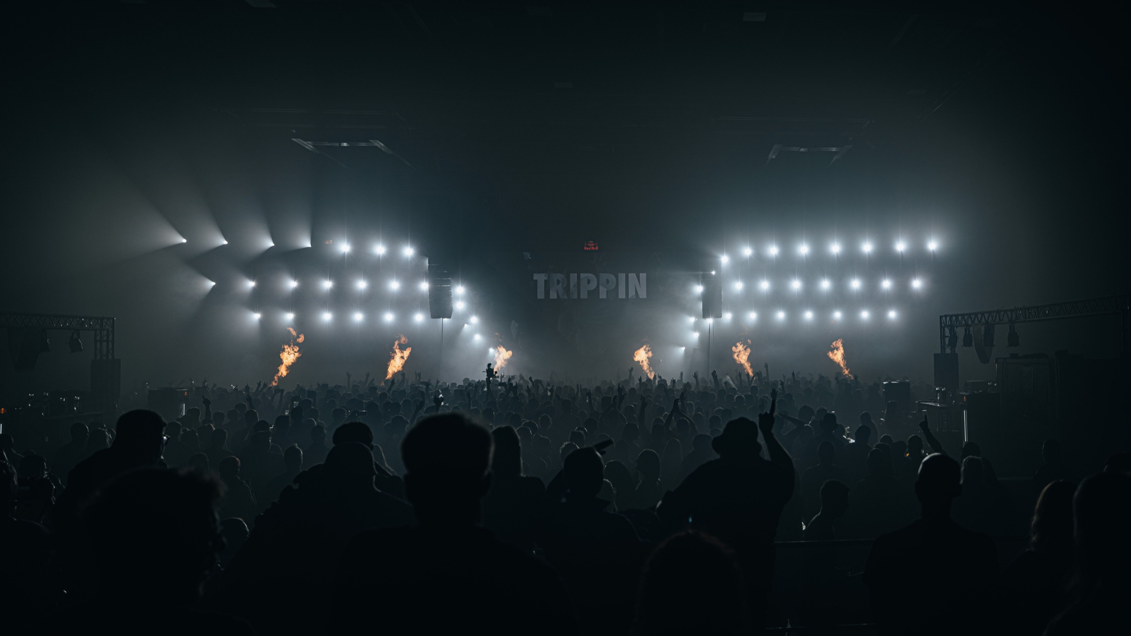 Blue beams over a dark crowd