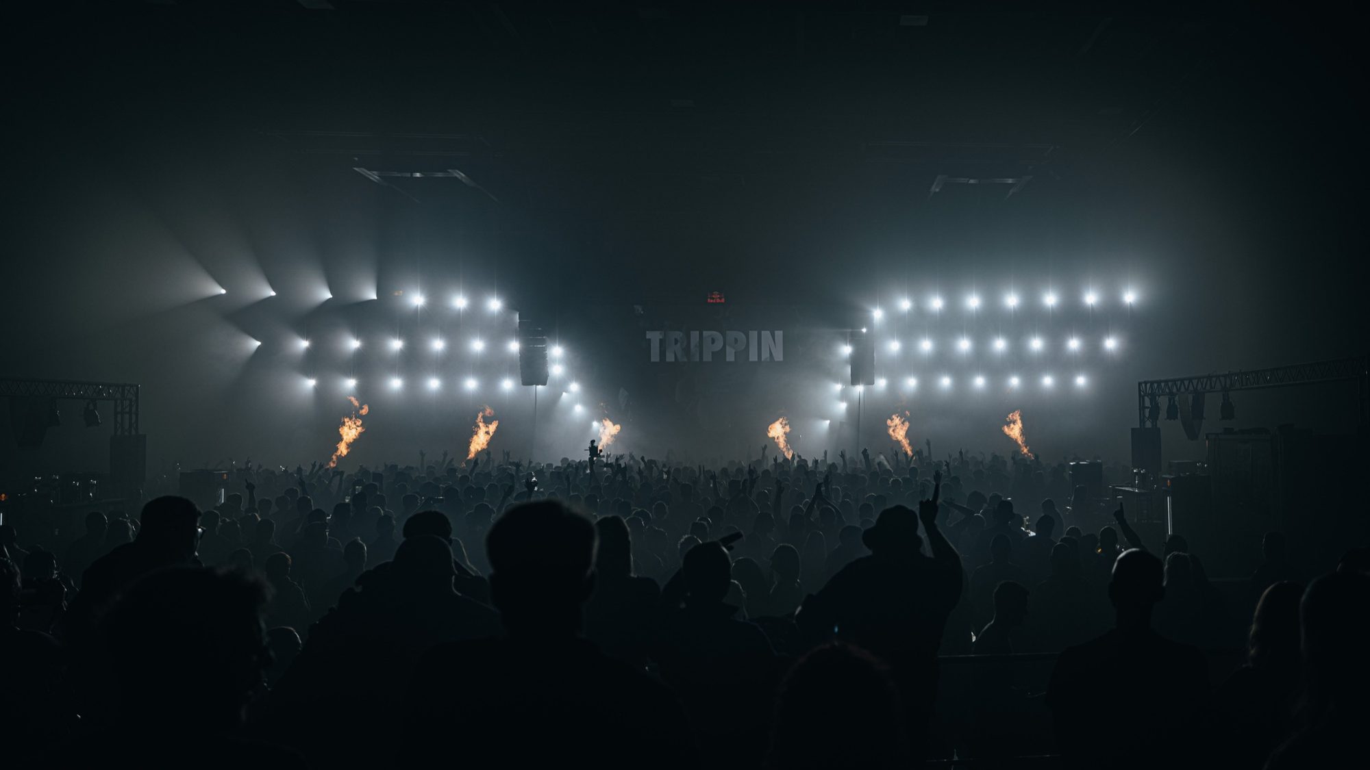 Blue beams over a dark crowd